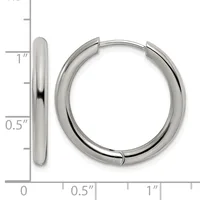 A pair of polished silver-tone hinged hoop earrings displayed next to a measurement scale showing approximately one inch in diameter and half an inch in width.
