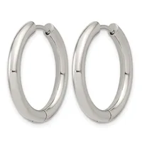 A pair of polished silver-toned chunky hoop earrings with hinged closures, displayed side by side against a white background.