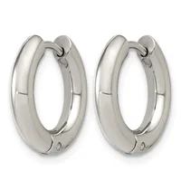 A pair of polished silver chunky hoop earrings with a curved, tubular design and hinged closures.