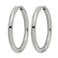 A pair of polished silver-toned hoop earrings with a rounded, tubular design and small hinged closures at the top.