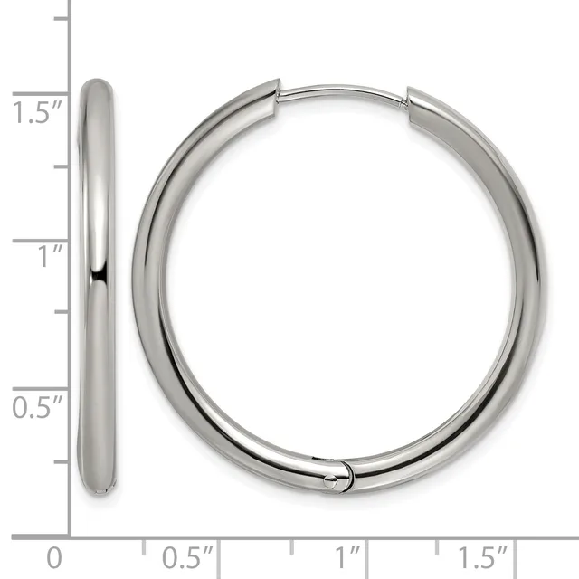 A pair of polished silver-toned hoop earrings shown from the side and front, measuring 1.5 inches in length with a thick tubular design.