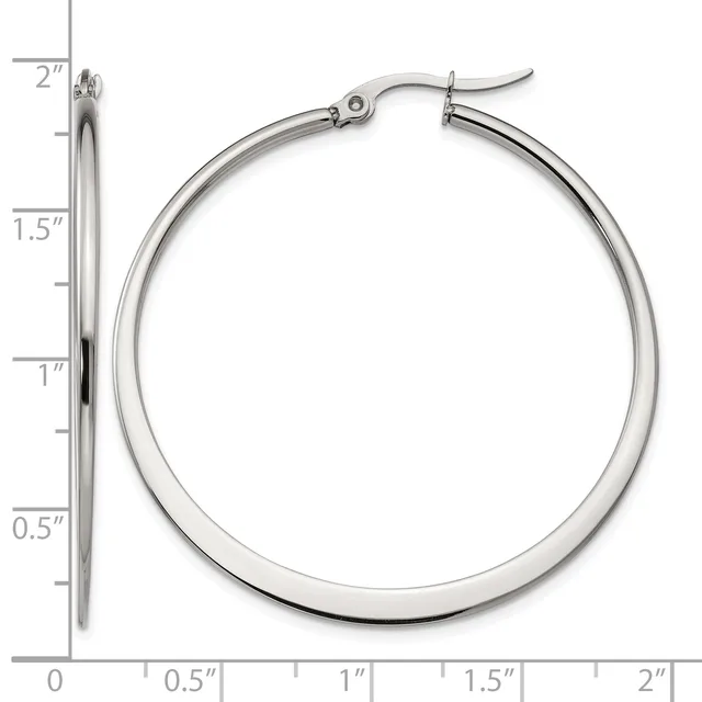 Polished silver-tone hoop earrings with a tube design and hinged posts, displayed next to a ruler showing they measure approximately 1.5 inches in diameter.