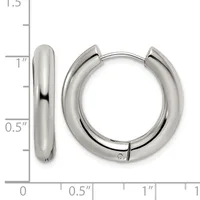 A pair of polished silver-toned chunky hoop earrings with hinged closures, shown next to a ruler for scale indicating approximately one inch in diameter.