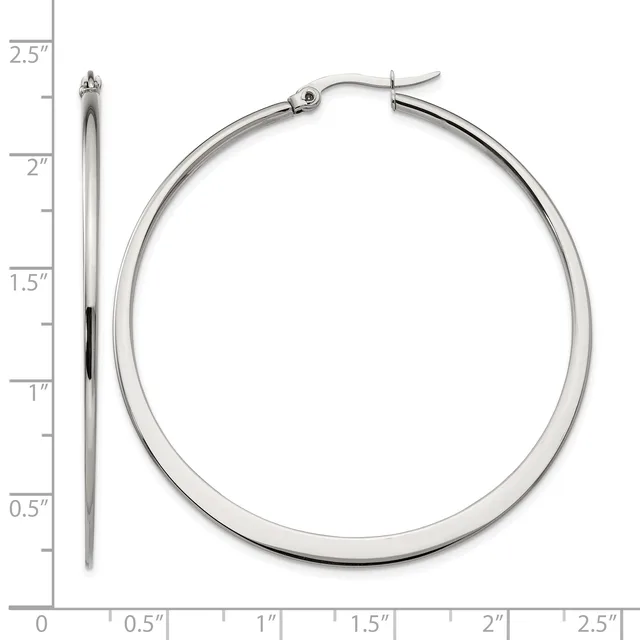 A pair of polished silver-toned hoop earrings displayed next to a ruler showing they measure approximately 2.5 inches in diameter.