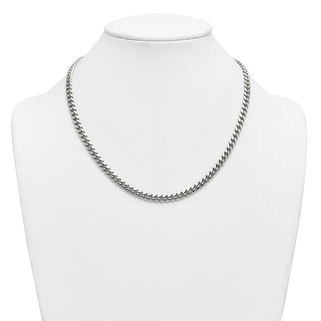 A silver-toned curb chain necklace displayed on a white mannequin bust.
