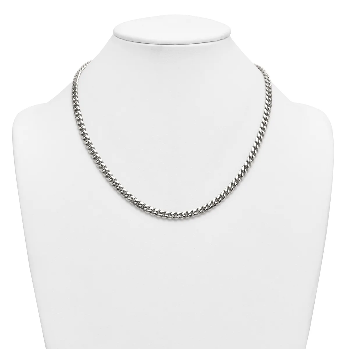 A silver-toned curb chain necklace displayed on a white mannequin bust.
