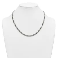A silver-toned curb chain necklace displayed on a white mannequin bust.