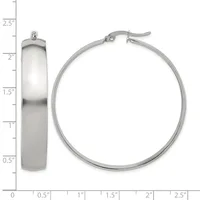 A pair of polished silver hoop earrings shown from front and side views with a measurement scale indicating approximately one inch in diameter and one-quarter inch in width.