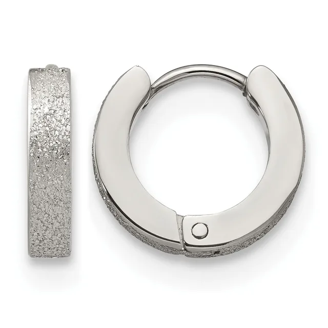 A pair of textured silver huggie hoop earrings shown from the front and side, featuring a sparkly sandblasted finish and a small hinged closure.