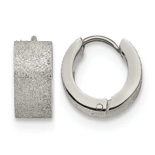 A pair of rectangular and circular silver-textured huggie earrings with hinged closures displayed against a white background.