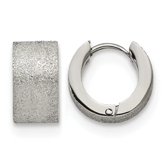 A pair of textured silver huggie hoop earrings displayed against a white background, shown from the front and side view.