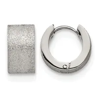 A pair of textured silver huggie hoop earrings displayed against a white background, shown from the front and side view.