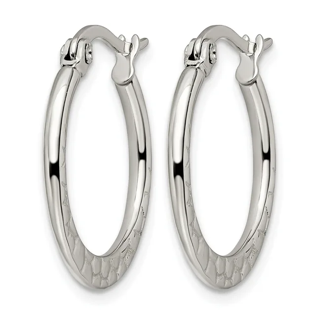 A pair of polished silver oval hoop earrings with textured bases and hinged closures, displayed against a white background.