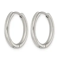 A pair of polished silver hoop earrings with textured ridged sides and hinged closures, shown from the front.