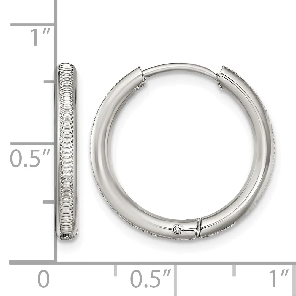 A pair of textured silver hoop earrings with a measurement scale showing they are approximately one inch in diameter.