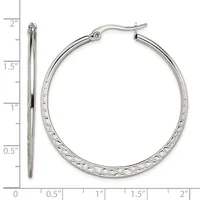 A pair of silver-toned hoop earrings with a textured diamond-cut surface, shown from front and side views next to a measurement ruler indicating they are approximately 1.5 inches in diameter.