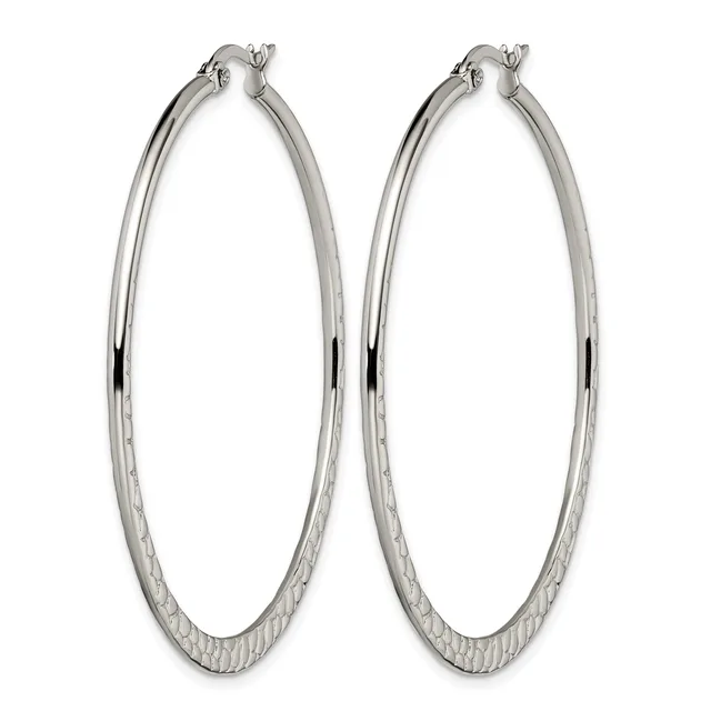 A pair of large silver-toned hoop earrings with a textured lower half and polished upper half, displayed against a white background.