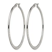 A pair of large silver-toned hoop earrings with a textured lower half and polished upper half, displayed against a white background.