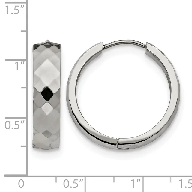A pair of silver hoop earrings with faceted surfaces displayed next to a side view of a single textured hoop earring on a measurement scale.