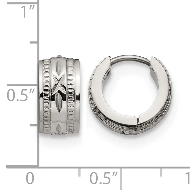 Pair of polished silver-toned chunky hoop earrings with textured center band and linear detailing, shown next to a measurement scale.