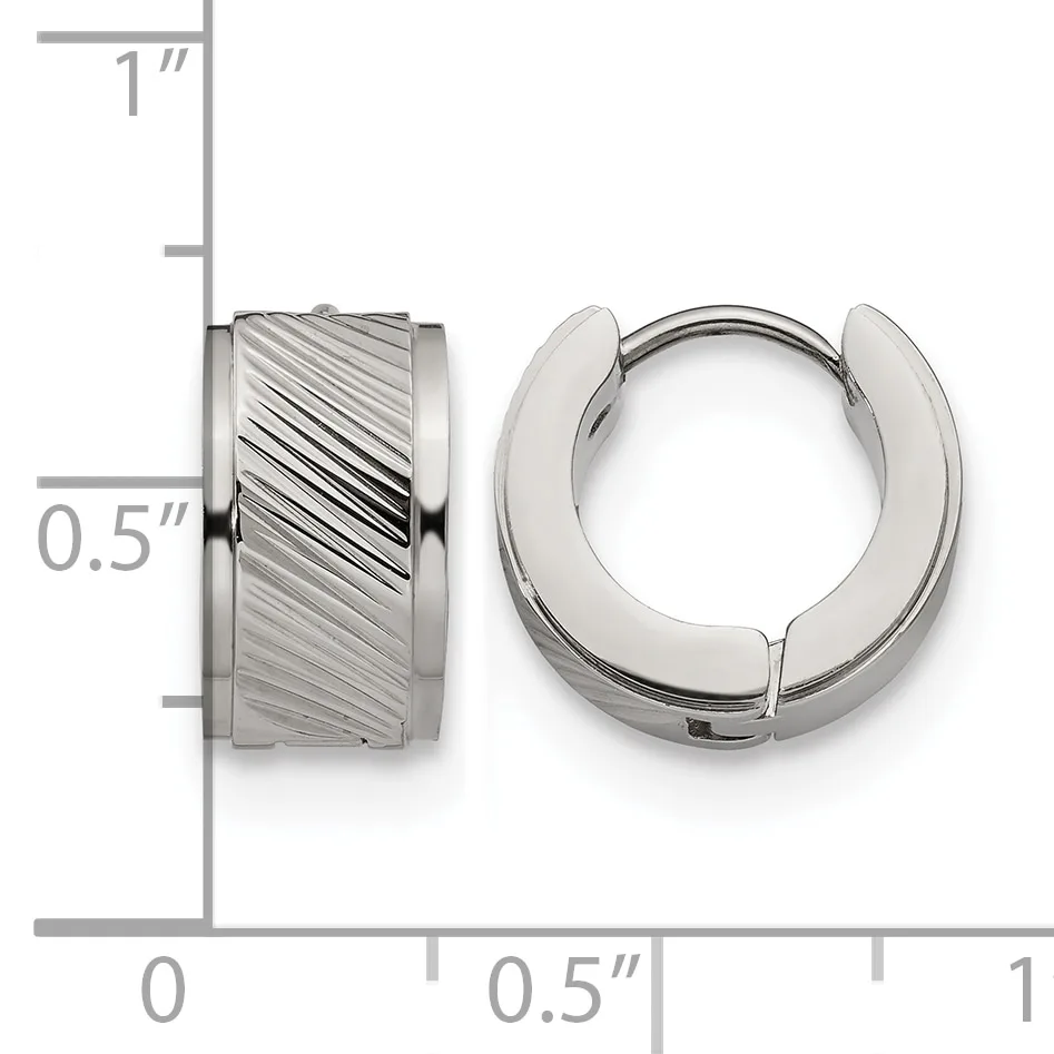 A pair of stainless steel huggie hoop earrings with diagonal textured finish on one earring and polished surface on the other, shown next to a ruler indicating approximately half-inch diameter.