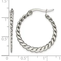 A pair of silver twisted hoop earrings with post and clutch backs, shown next to a ruler measuring approximately 1.25 inches in diameter.