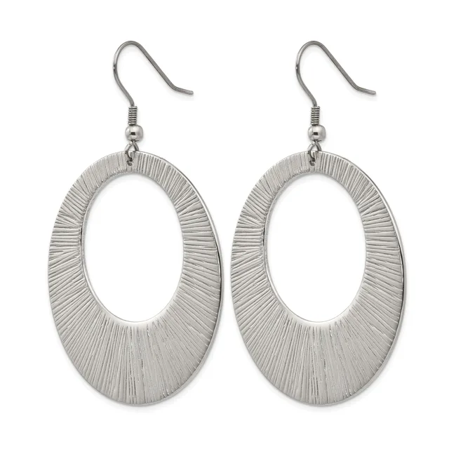 A pair of silver-toned oval dangle earrings with textured linear surface patterns, suspended from hook-style ear wires.