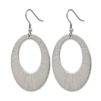 A pair of silver-toned oval dangle earrings with textured linear surface patterns, suspended from hook-style ear wires.