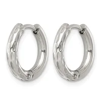 A pair of silver hoop earrings with a textured, dimpled surface and hinged closures, displayed side by side.