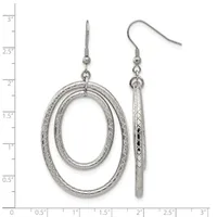 A pair of silver dangle earrings featuring textured oval loops on the left and textured cylindrical rods on the right, displayed against a measurement ruler.