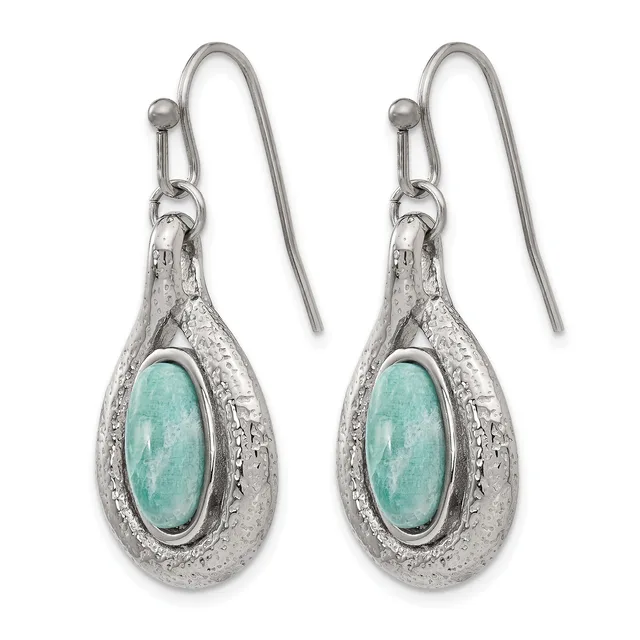 A pair of silver teardrop earrings with turquoise oval cabochon centers and textured metal surrounds, suspended from hook-style ear wires.