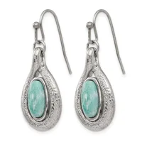 A pair of silver teardrop earrings with turquoise oval cabochon centers and textured metal surrounds, suspended from hook-style ear wires.