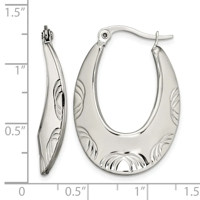 A pair of polished silver hoop earrings with textured leaf pattern details, displayed next to a measurement scale showing approximately one inch in height.
