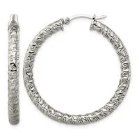A pair of silver hoop earrings with a textured, hammered surface and hinged post closures, shown from front and side views.