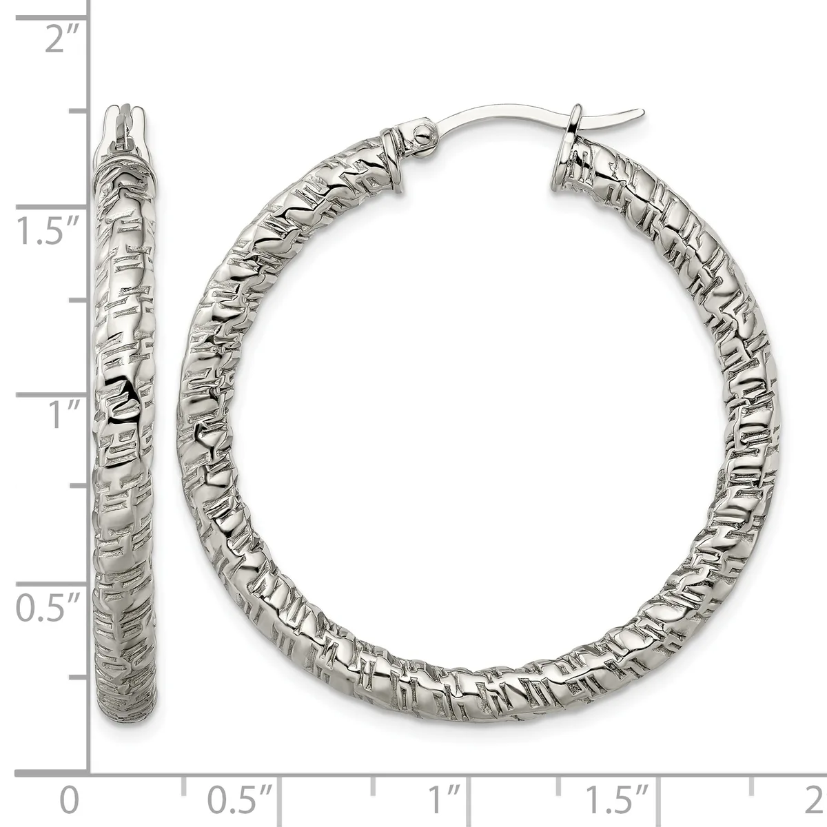 A pair of textured silver hoop earrings with a hammered surface finish, displayed against a ruler showing they measure approximately 1.5 inches in diameter.