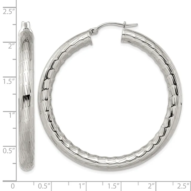 A pair of silver textured hoop earrings with hinged posts, displayed against a measurement scale showing they are approximately 2.25 inches long.