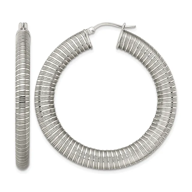 A pair of silver-toned textured hoop earrings with a ridged surface pattern, shown from the front with one earring displayed separately on the left.