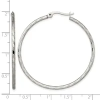Silver-toned twisted hoop earrings displayed next to a measurement ruler showing approximately two inches in diameter.
