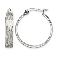 A pair of silver hoop earrings, one displaying a textured braided pattern and the other a smooth polished finish, both with hook closures.