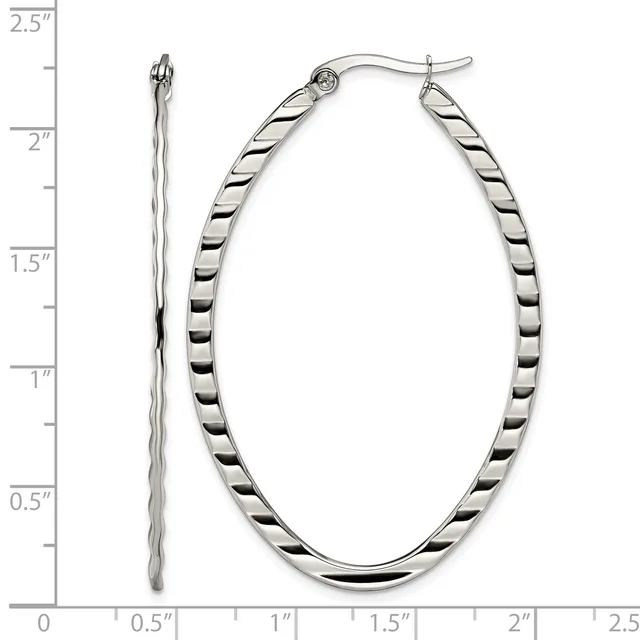 A pair of silver twisted oval hoop earrings displayed next to a measurement scale showing they are approximately 2 inches long.