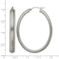 Two silver textured hoop earrings displayed next to a measurement scale, shown from front and side angles with post and clutch closures.