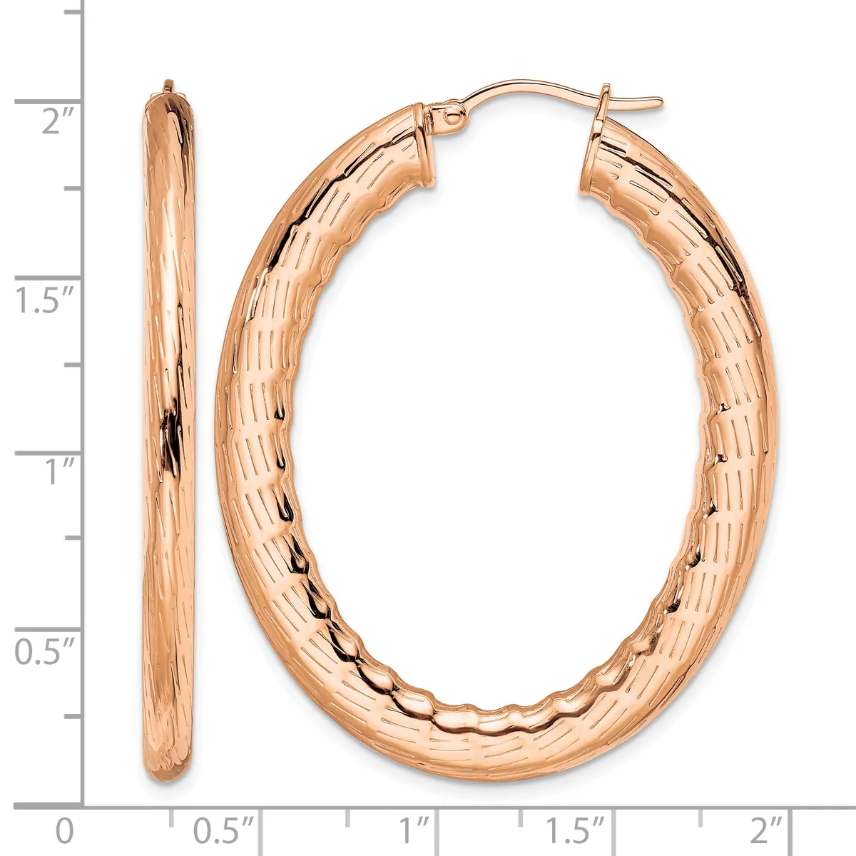 A pair of rose gold hoop earrings with a textured surface, shown next to a ruler measuring approximately two inches in length.