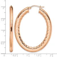 A pair of rose gold hoop earrings with a textured surface, shown next to a ruler measuring approximately two inches in length.