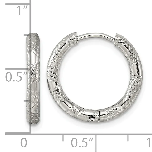 A pair of silver textured hoop earrings with a hammered finish, shown from front and side views next to a measurement scale indicating approximately one inch in height and half inch in width.