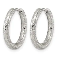 A pair of silver hoop earrings with a textured, hammered surface finish and hinged closures, displayed side by side.