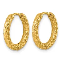 A pair of gold hoop earrings with a textured, dimpled surface finish shown against a white background.