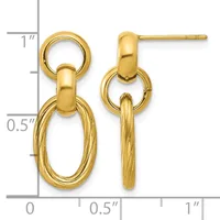 Gold-toned dangle earrings with polished and textured oval rings, shown next to a measurement scale indicating approximately one inch in length.