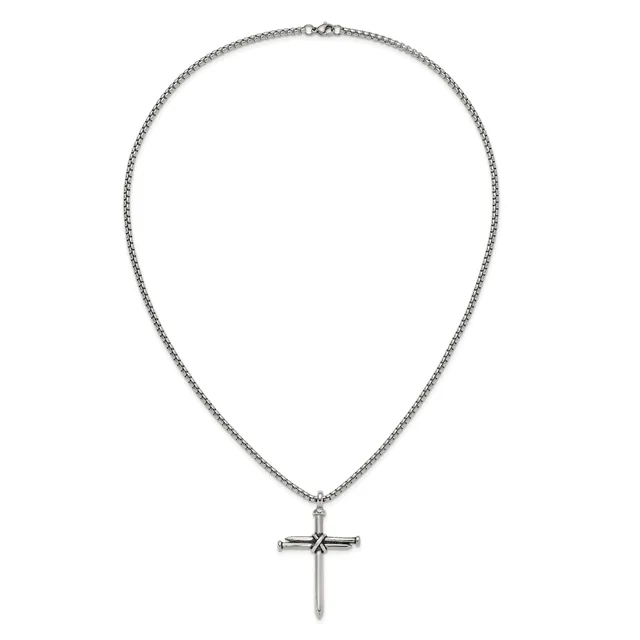 Silver-toned chain necklace with a decorative cross pendant featuring a small dark stone or detail at the center.
