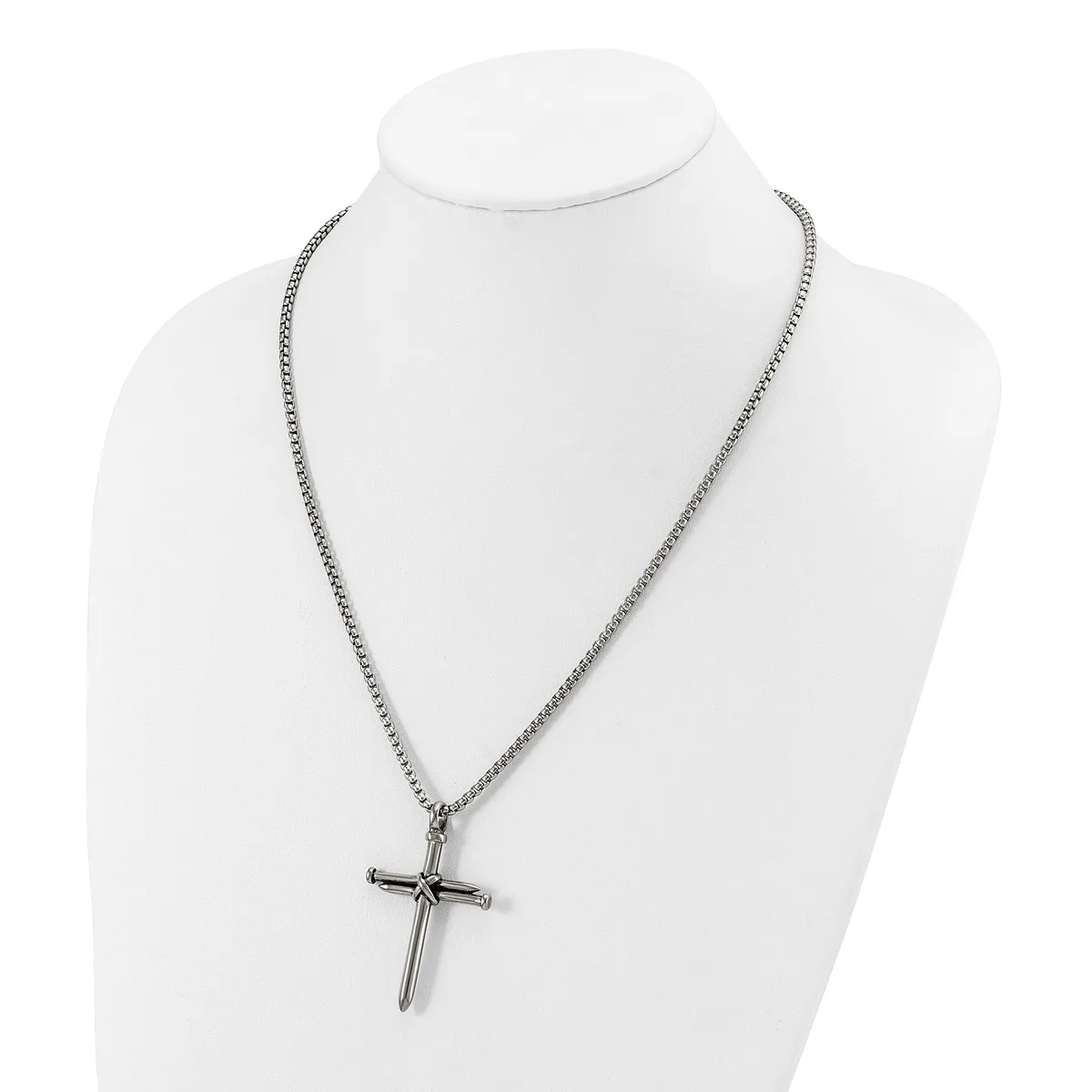 Silver-toned chain necklace with a cross pendant displayed on a white mannequin bust.