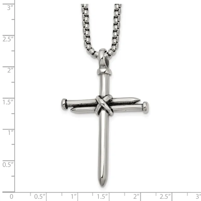 Stainless steel cross pendant with wrapped detail at center, hanging from a curb chain, shown against a measurement scale.